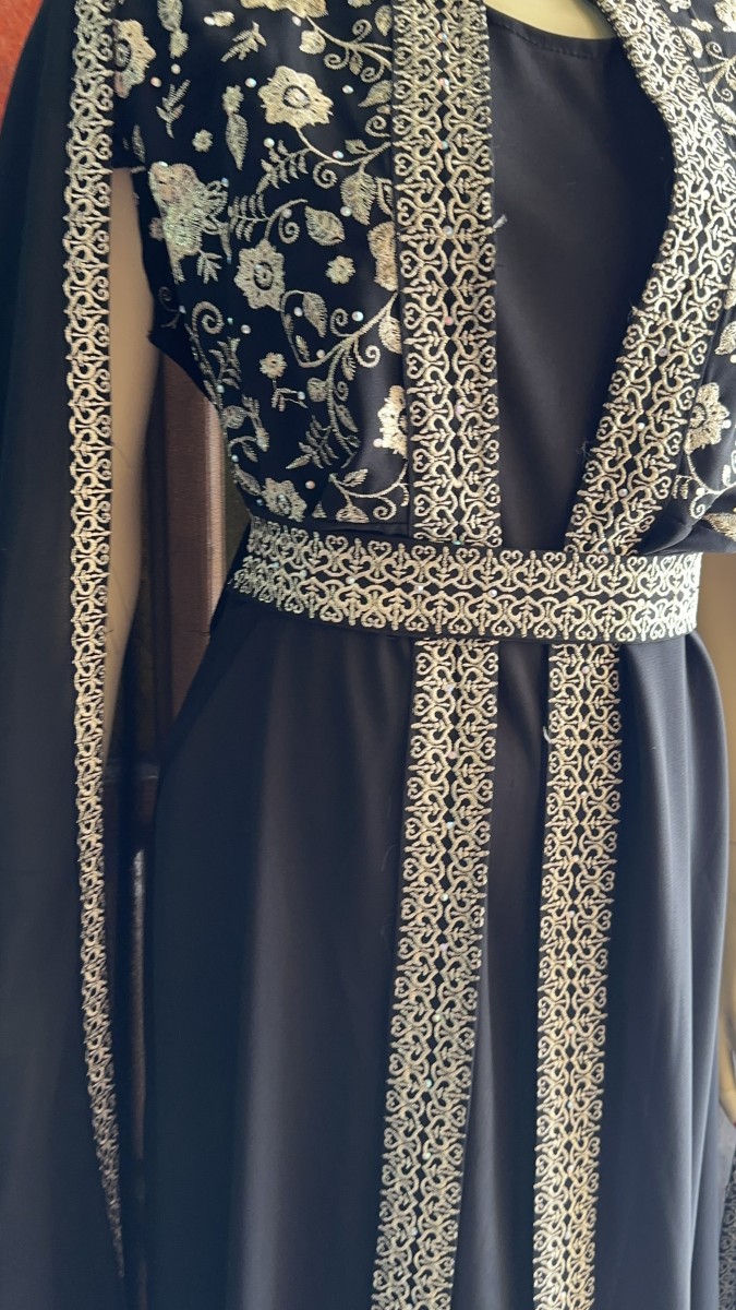 A timeless black abaya adorned with exquisite oriental golden embroidery — the perfect choice for brides and special occasions.