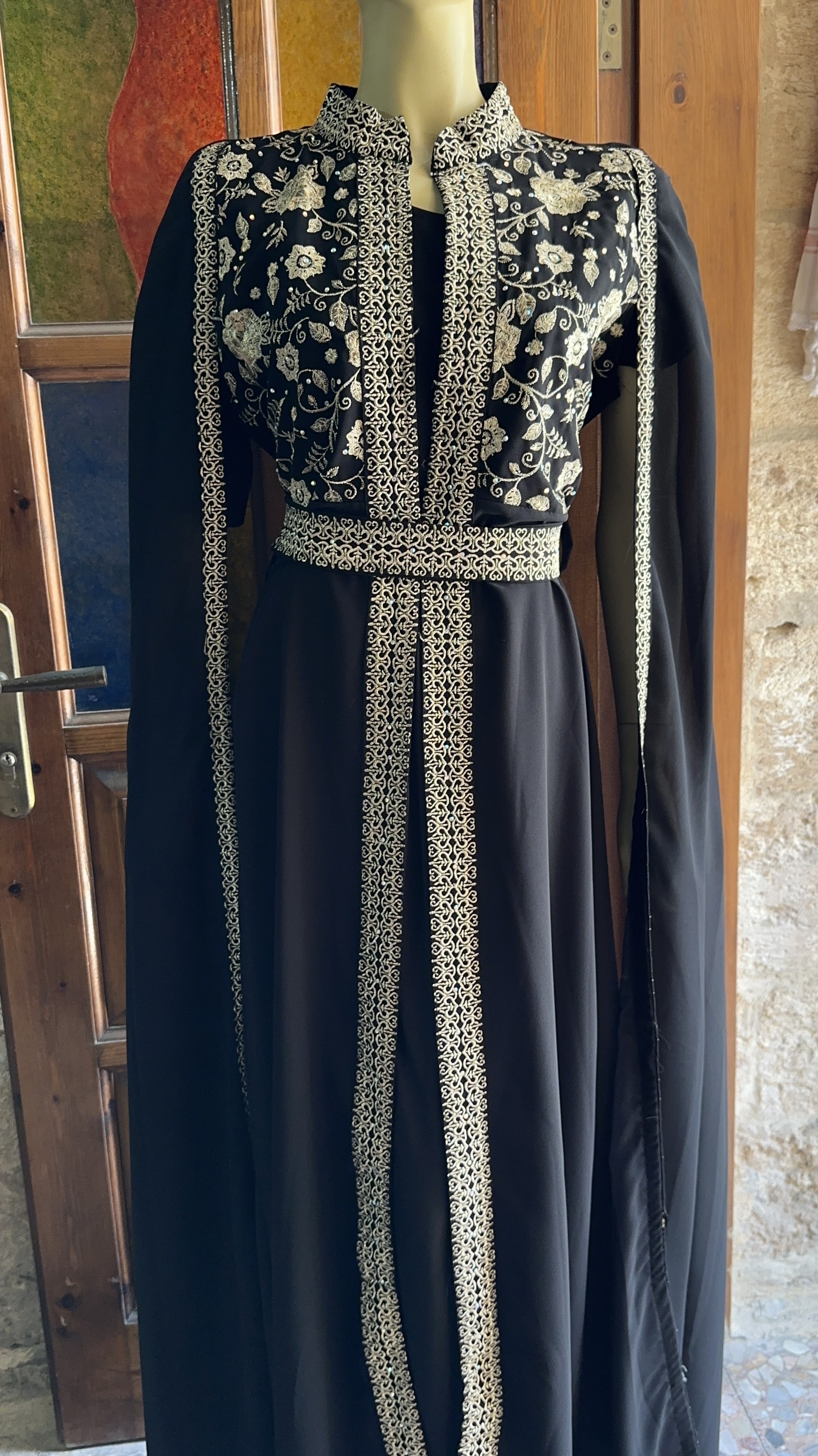A timeless black abaya adorned with exquisite oriental golden embroidery — the perfect choice for brides and special occasions.